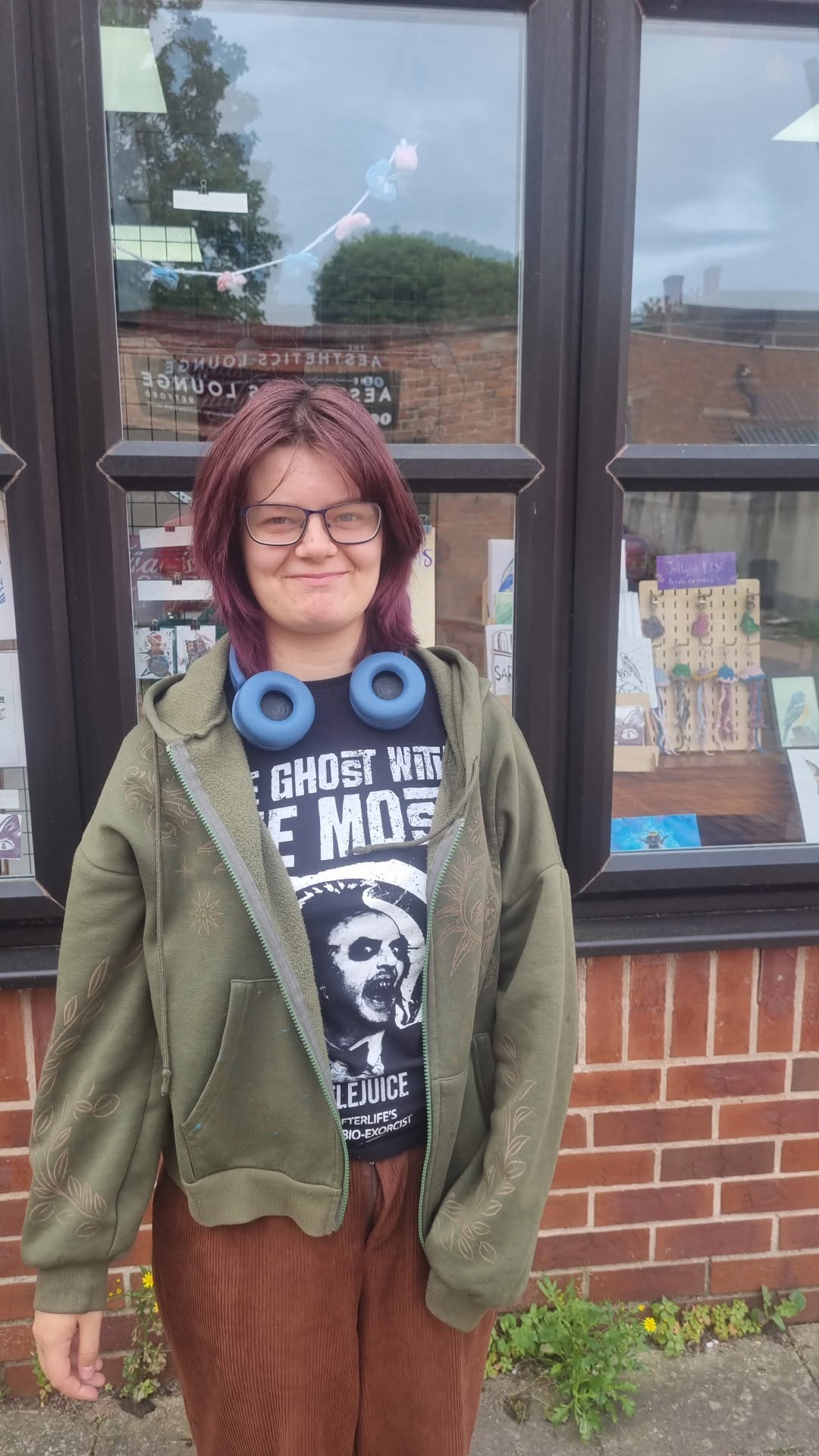 The artist standing outside the studio shop window display